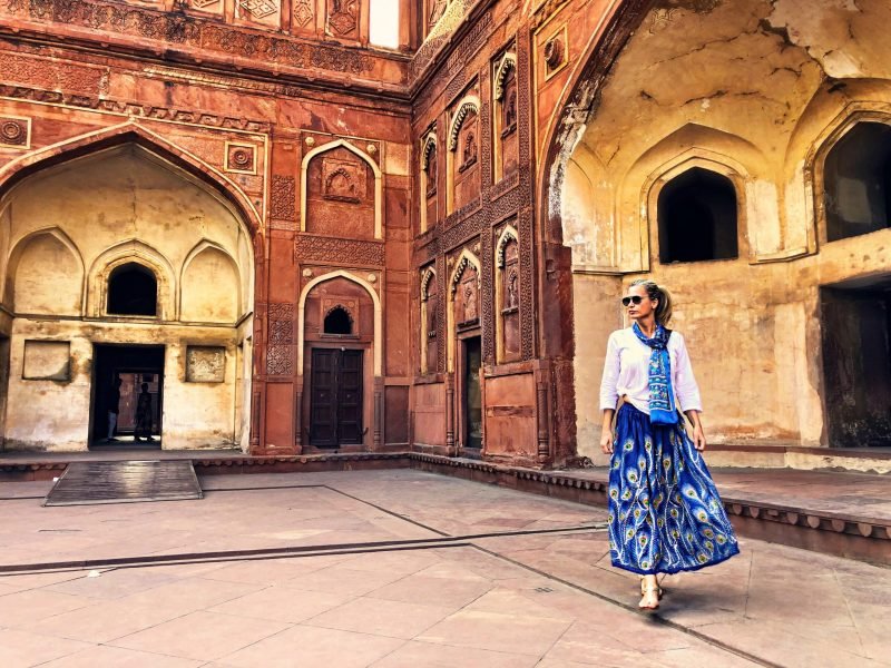full-length-woman-walking-against-historic-building-min